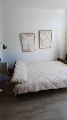 a bedroom with a bed and a table and a couch at ConchaBeach Valencia in Valencia