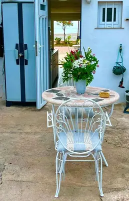 a table and chairs with a potted plant on it at Loft con encanto junto al mar in Barrio-Mar