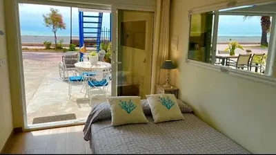 a room with a bed with a view of a patio at Loft con encanto junto al mar in Barrio-Mar