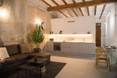 a living room with a couch and a kitchen at Can Turia in Valencia