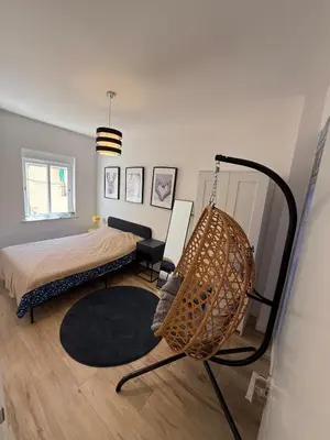 a bedroom with a bed and a swing at Large New House with Terraces and Air Conditioning in Cullera