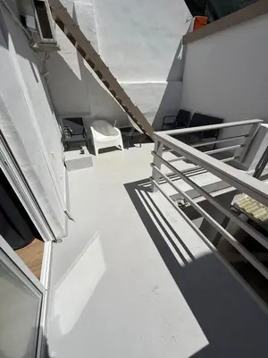 a white stairway with a white chair in a building at Large New House with Terraces and Air Conditioning in Cullera