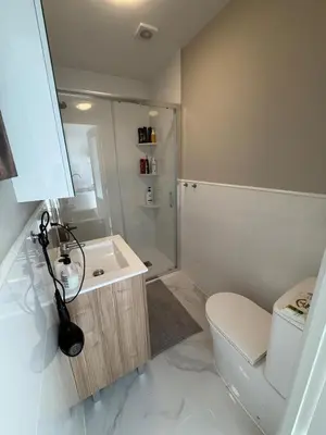 a bathroom with a toilet and a sink and a shower at Large New House with Terraces and Air Conditioning in Cullera