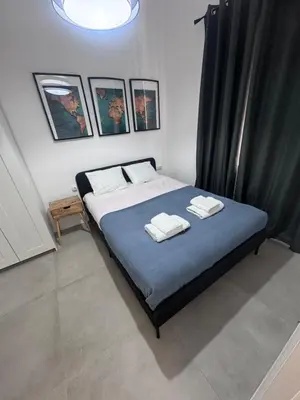 a bedroom with a bed with two towels on it at Large New House with Terraces and Air Conditioning in Cullera