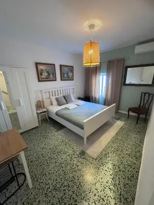 a bedroom with a bed and a chandelier at Large New House with Terraces and Air Conditioning in Cullera
