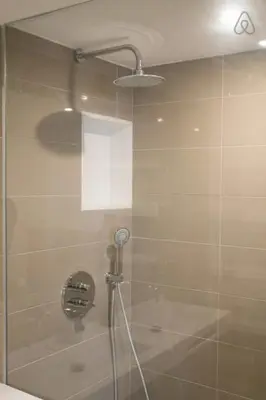 a shower with a glass door in a bathroom at Austria 4 in Valencia