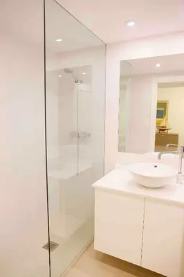 a bathroom with a glass shower and a sink at Austria 4 in Valencia