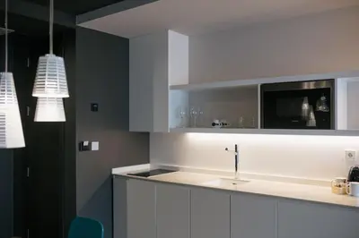 a kitchen with white cabinets and a sink at MYR Plaza Mercado & Spa in Valencia