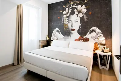 a bedroom with a bed with a painting of a woman at MYR Plaza Mercado & Spa in Valencia