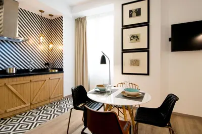 a kitchen and dining room with a white table and chairs at MYR Plaza Mercado & Spa in Valencia