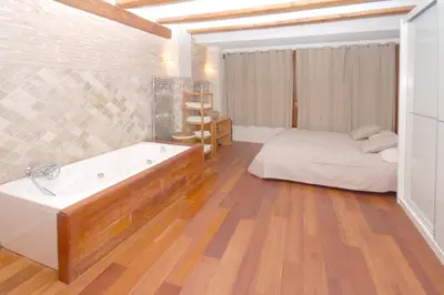 a bathroom with a tub and a bed in a room at Beds & Breaks Ravel I in Valencia