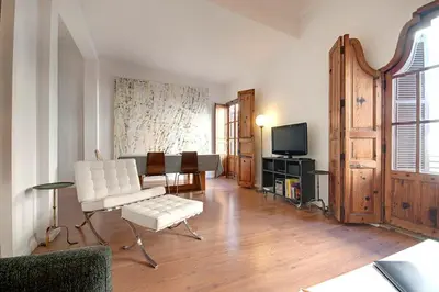 a living room with white furniture and a tv at Beds & Breaks Strauss in Valencia
