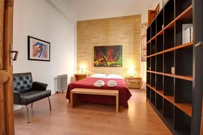 a room with a mirror and a bed and a table at Beds & Breaks Strauss in Valencia