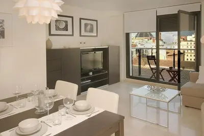 a living room with a dining table and a television at Beds & Breaks Soler in Valencia