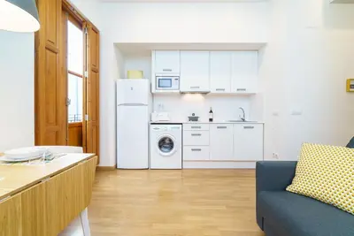 a kitchen with a refrigerator and a washing machine at Valencia Home Carmen in Valencia