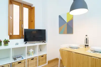 a living room with a tv and a table at Valencia Home Carmen in Valencia