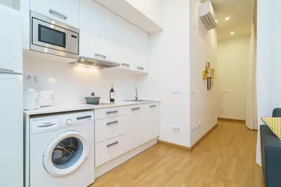 a white kitchen with a washer and dryer at Valencia Home Carmen in Valencia