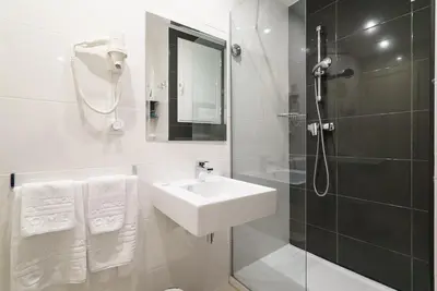 a white bathroom with a sink and a shower at Valencia Home Carmen in Valencia