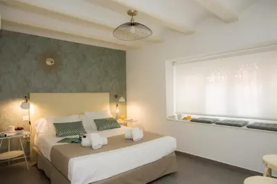 a bedroom with a large bed and a window at SingularStays Botanico 29 Rooms in Valencia