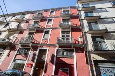 a red building with balconies on the side of it at SingularStays Botanico 29 Rooms in Valencia