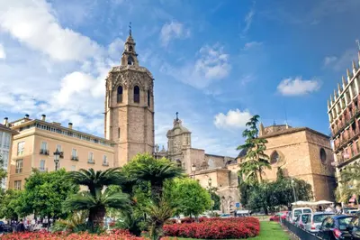 an old building with a clock tower in a city at SingularStays Botanico 29 Rooms in Valencia