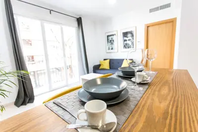 a dining room with a table with plates and wine glasses at Total Valencia Old City Luxury in Valencia