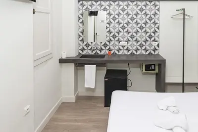 a bathroom with a sink and a mirror at NWT Central Station Valencia in Valencia
