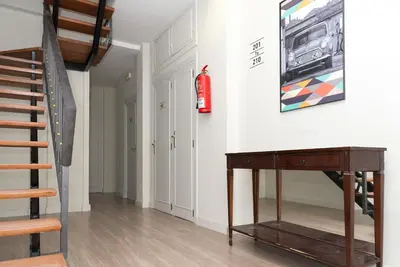a room with a staircase and a fire extinguisher on the wall at NWT Central Station Valencia in Valencia