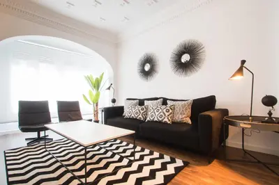 a living room with a couch and two mirrors on the wall at Valencia Luxury - Boutique Center in Valencia