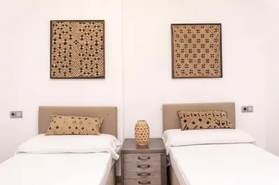 two beds in a room with white walls at Valencia Luxury - Boutique Center in Valencia