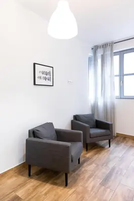a living room with two chairs and a couch at Down Town in Valencia