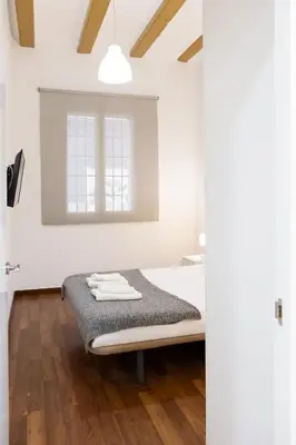 a white room with a bed and a window at Down Town in Valencia