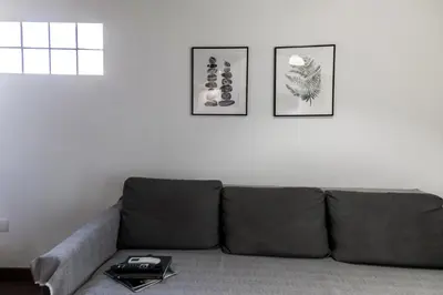 a couch in a living room with two pictures on the wall at Down Town in Valencia