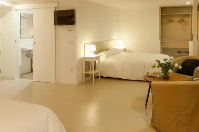 a hotel room with two beds and a table at Host & Home in Valencia