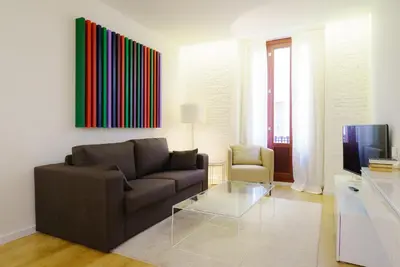 a living room with a couch and a tv at Valencia Luxury - Boutique Redonda in Valencia