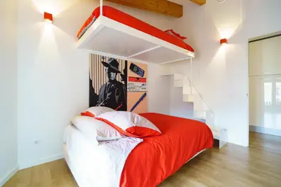 a bedroom with a red and white bed and a staircase at Valencia Luxury - Boutique Redonda in Valencia