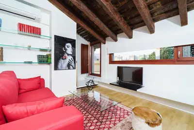 a living room with a red couch and a tv at Valencia Luxury - Boutique Redonda in Valencia