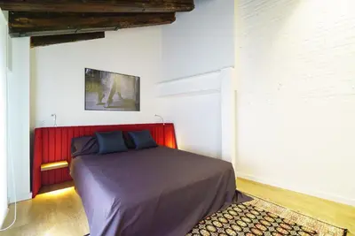 a bedroom with a bed with a red headboard at Valencia Luxury - Boutique Redonda in Valencia