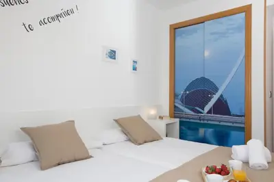 a bedroom with a bed with a view of a building at SingularStays Artes in Valencia