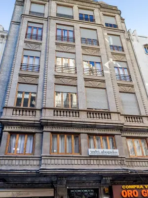 a tall building with windows on the side of it at Travel Habitat Ayuntamiento in Valencia