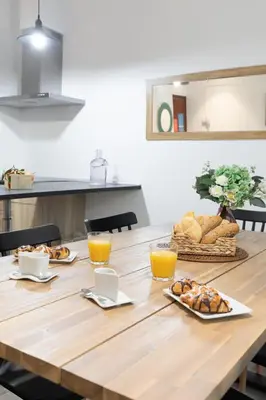 a table with bread and orange juice on it at Travel Habitat Ayuntamiento in Valencia