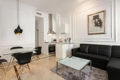a living room with a couch and a table at Baron Suites Reina in Valencia