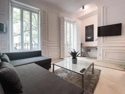 a living room with a couch and a coffee table at Baron Suites Reina in Valencia