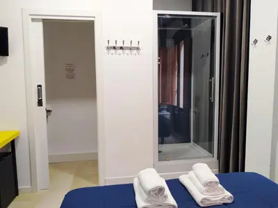 a room with a mirror and three towels on a bed at Flats Friends Plaza de la Reina in Valencia