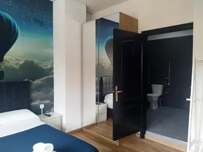 a bedroom with a bed and a mural of a universe at Flats Friends Plaza de la Reina in Valencia