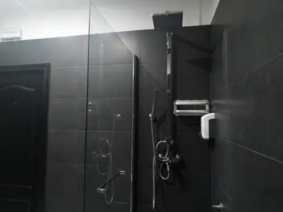 a shower in a bathroom with a glass door at Flats Friends Plaza de la Reina in Valencia