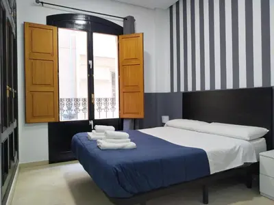 a bedroom with a bed with towels on it at Flats Friends Plaza de la Reina in Valencia