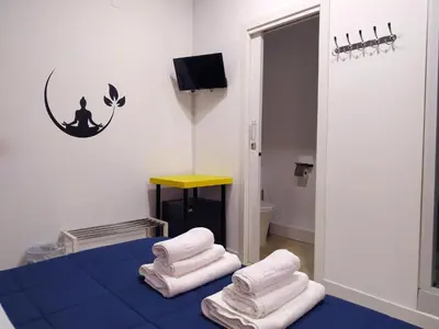 a room with a blue bed with towels on it at Flats Friends Plaza de la Reina in Valencia