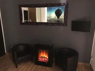 a living room with a fireplace and a mirror at Flats Friends Plaza de la Reina in Valencia