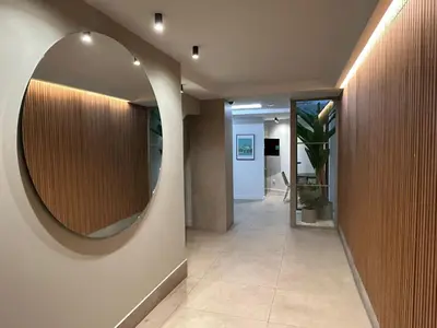 a hallway with a large round mirror on the wall at Poeta Llombart Apartment in Valencia